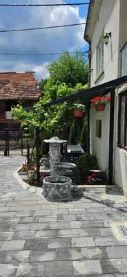 a stone fountain in the middle of a courtyard at Temački amanet in Pirot