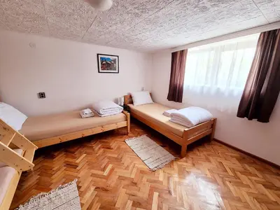 a room with two beds and a window at Temački amanet in Pirot