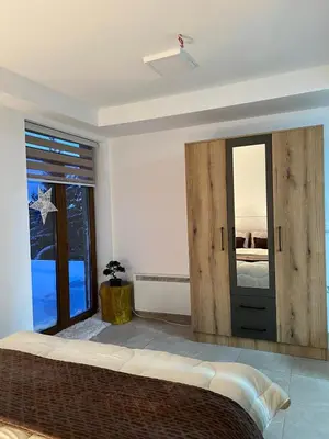 a bedroom with a bed and a large mirror at Apartman Vučko in Kopaonik