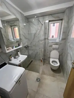 a bathroom with a shower and a toilet and a sink at Eden Apartman Vrnjačka Banja in Vrnjačka Banja