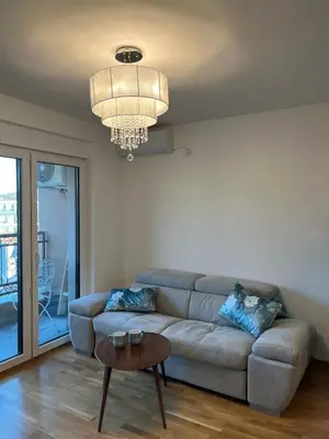 a living room with a couch and a table at Eden Apartman Vrnjačka Banja in Vrnjačka Banja