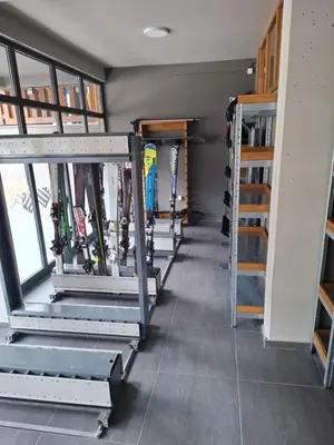 a row of ski racks in a room with skis at TomaR-Gondola in Kopaonik