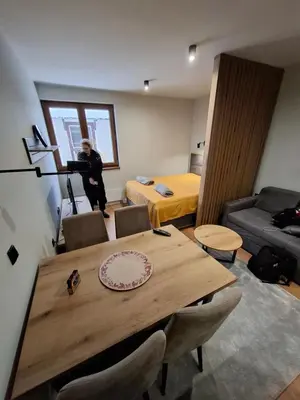 a person is standing in a room with a table at TomaR-Gondola in Kopaonik