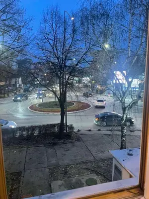 a view from a window of a street with cars at Sindjelicev trg apartment in Niš