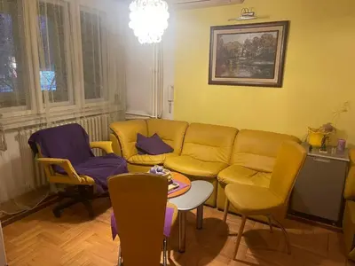 a living room with a couch and chairs and a table at Sindjelicev trg apartment in Niš