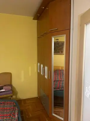 a room with a closet and a bed in it at Sindjelicev trg apartment in Niš