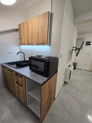 a kitchen with a sink and a microwave on a counter at Doksim Luxury Apartments 201 in Pirot