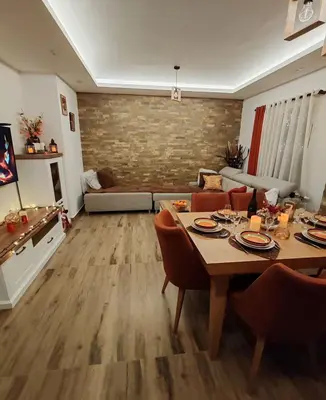 a living room with a table and chairs and a couch at Apartman MPS Kopaonik-Free Spa in Kopaonik