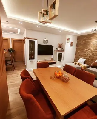 a living room with a wooden table and chairs at Apartman MPS Kopaonik-Free Spa in Kopaonik