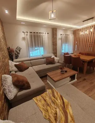 a living room with a couch and a table at Apartman MPS Kopaonik-Free Spa in Kopaonik