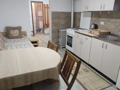a small kitchen with a table and a sink at Apartman BREG in Pirot
