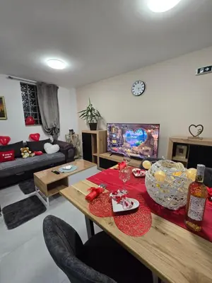 a living room with a table and a couch at Doksim Luxury Apartments 202 in Pirot