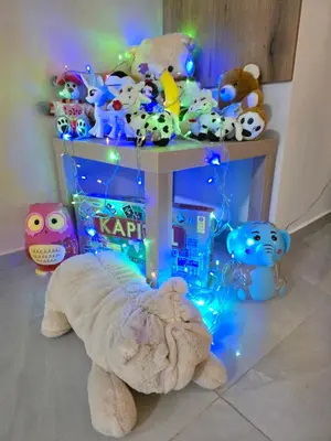 a group of stuffed animals on a table with lights at Doksim Luxury Apartments 202 in Pirot