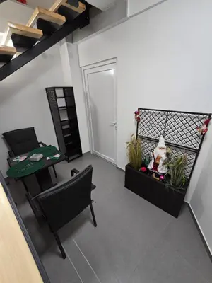 a view of a living room with a table and chairs at Doksim Luxury Apartments 202 in Pirot