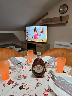 a table with a bottle of alcohol on top of it at Doksim Luxury Apartments 301 in Pirot
