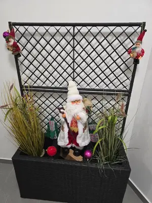 a santa claus figurine in a planter with plants at Doksim Luxury Apartments 301 in Pirot