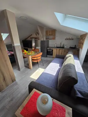 a living room with a couch and a kitchen at Doksim Luxury Apartments 301 in Pirot