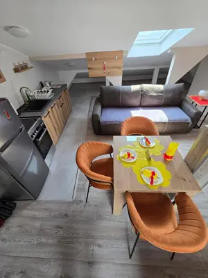 a kitchen and living room with a table and chairs at Doksim Luxury Apartments 301 in Pirot