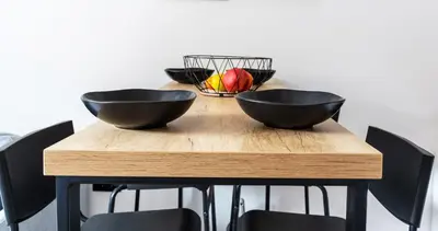 a wooden table with two black bowls on it at Studio Bele Staze Central in Brzeće