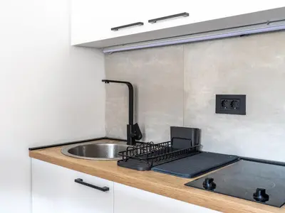 a kitchen counter with a sink and a stove at Studio Bele Staze Central in Brzeće