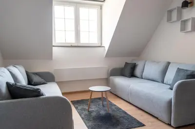 a living room with two couches and a table at Studio Bele Staze Central in Brzeće