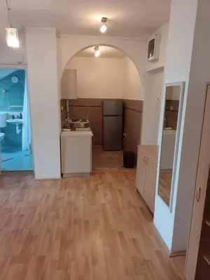 an empty kitchen with an archway in a room at Niš,centar udobnosti in Niš