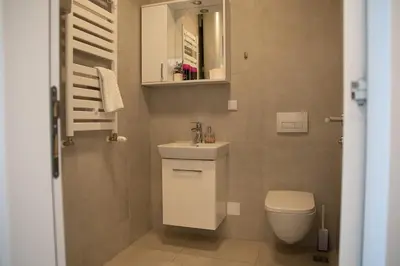a small bathroom with a sink and a toilet at Planet Residence Royal Studio & SPA in Niš