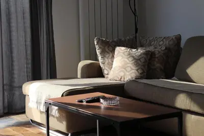 a living room with a couch and a coffee table at Planet Residence Royal Studio & SPA in Niš