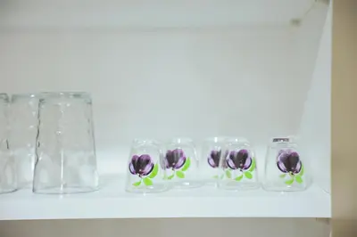 a row of glass jars with purple flowers on a shelf at Alles Ski in Brzeće