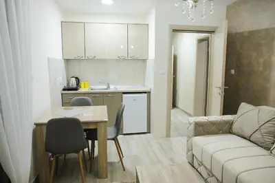 a kitchen and a living room with a couch and a table at Alles Ski in Brzeće