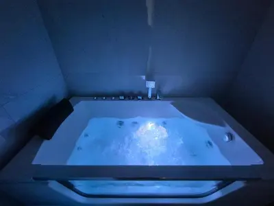 a jacuzzi tub with a light in a room at Pirotski amanet in Pirot