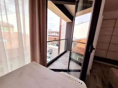 a room with a balcony with a table and a window at Pirotski amanet in Pirot