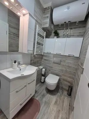 a bathroom with a white sink and a toilet at Pirotski amanet in Pirot