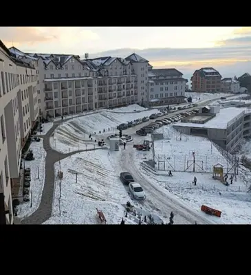 a city street with snow on the ground and buildings at Apartmani Aki in Kopaonik