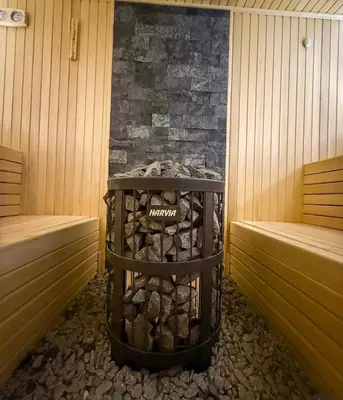 a sauna with a stack of logs in a room at Hop na Kop Residence Hill App 103 in Kopaonik