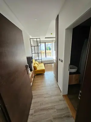 a hallway with a yellow chair in a room at Hop na Kop Residence Hill App 103 in Kopaonik