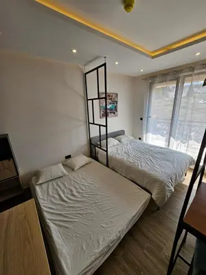 a bedroom with two beds and a window at Hop na Kop Residence Hill App 103 in Kopaonik