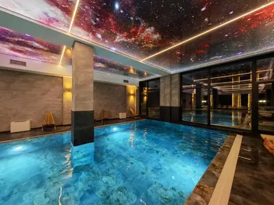 a swimming pool with a starry sky mural on the wall at Kop San Residence Hill in Kopaonik