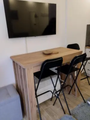 a wooden table with two chairs and a mirror at Kop San Residence Hill in Kopaonik