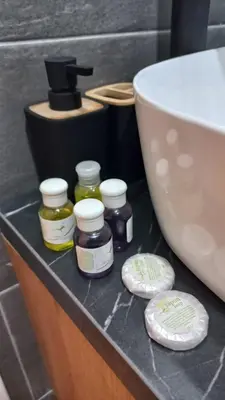 a bathroom counter with jars of honey and a sink at Kop San Residence Hill in Kopaonik