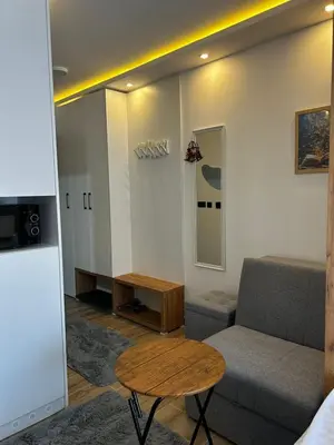 a living room with a couch and a table at Kop San Residence Hill in Kopaonik