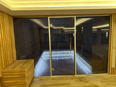 an empty room with a glass door with a bench at Apartment S65a Milmari Resort,Kopaonik in Raška