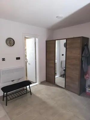 a living room with a sliding door and a mirror at Apartment S65a Milmari Resort,Kopaonik in Raška