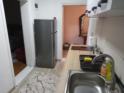a kitchen with a sink and a stainless steel refrigerator at Apartman Milosavljević in Železnička Stanica Ćele Kula