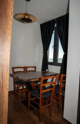 a dining room with a table and some chairs at KonKal - Royal resort in Kopaonik