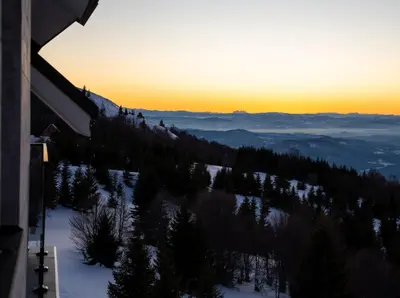 a view of a snow covered mountain at sunset at KonKal - Royal resort in Kopaonik