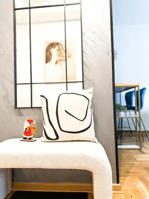 a pillow sitting on a bench in a living room at ORDO Apartments in Vrnjačka Banja
