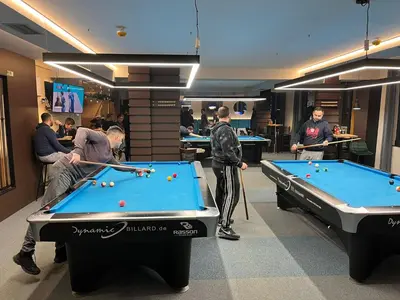 a group of people playing pool in a room at ORDO Apartments in Vrnjačka Banja