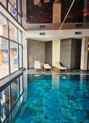 a large swimming pool in a building at Apartman B64 Residence Hill Kopaonik in Kopaonik