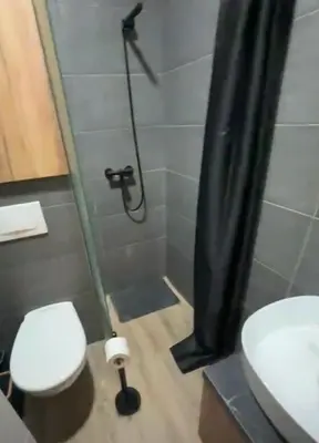 a bathroom with a shower with a toilet and a sink at Apartman B64 Residence Hill Kopaonik in Kopaonik